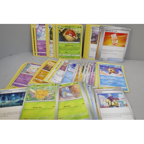 2312 - A box of over 600 Pokémon cards including holographic and rare cards with a large promo card