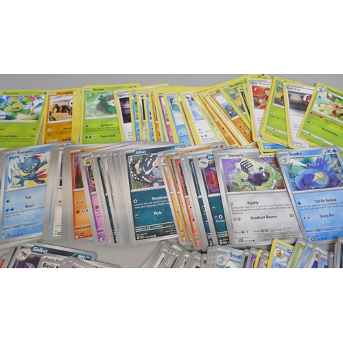 2313 - A box of over 600 Pokémon cards including holographic and rare cards with a large promo card