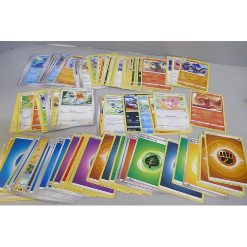 2313 - A box of over 600 Pokémon cards including holographic and rare cards with a large promo card