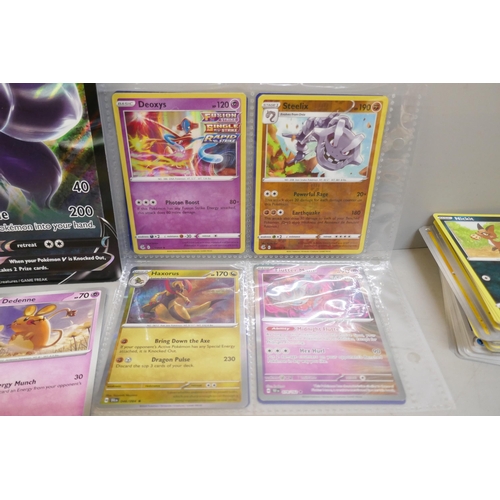 2313 - A box of over 600 Pokémon cards including holographic and rare cards with a large promo card