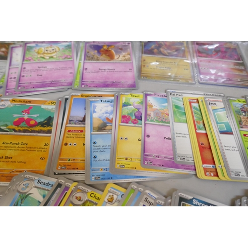 2313 - A box of over 600 Pokémon cards including holographic and rare cards with a large promo card