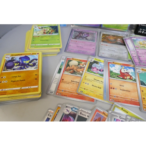 2313 - A box of over 600 Pokémon cards including holographic and rare cards with a large promo card