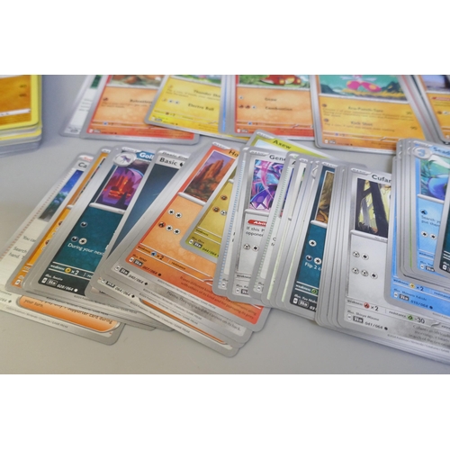 2313 - A box of over 600 Pokémon cards including holographic and rare cards with a large promo card