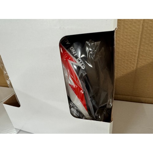 5211 - A box of 10 black, red and white cycle helmets