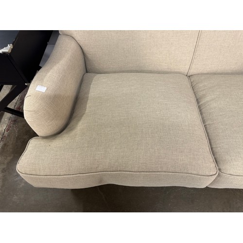 3068 - A Howard beige fabric upholstered sofa