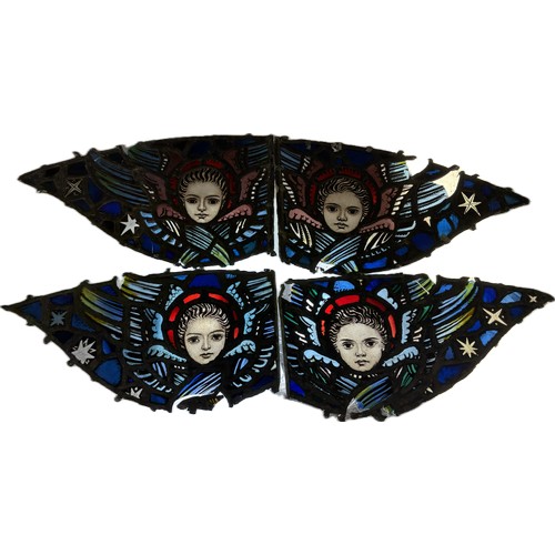 9069 - Four Ecclesiastical leaded stained glass panels, depicting faces of angels, 30 x 55cms