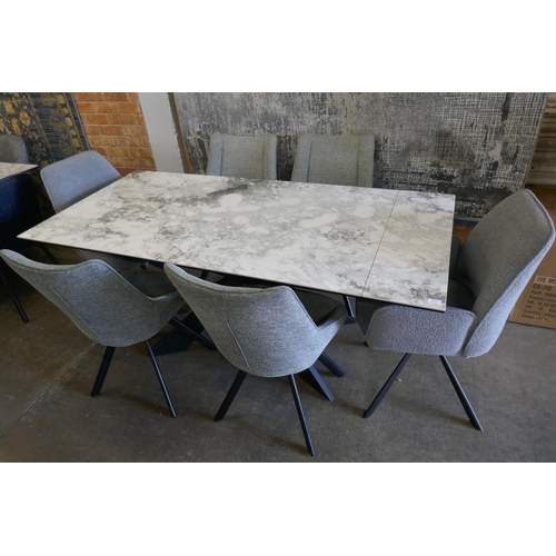 3287 - A Kos extending dining table and six static grey fabric upholstered swivel dining chairs *This lot i... 