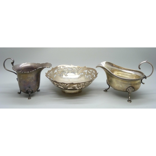 7358 - Two silver jugs and a pierced silver dish, 292g