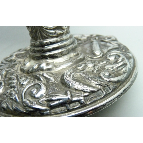 7359 - A pair of embossed silver candlesticks, 9.5cm