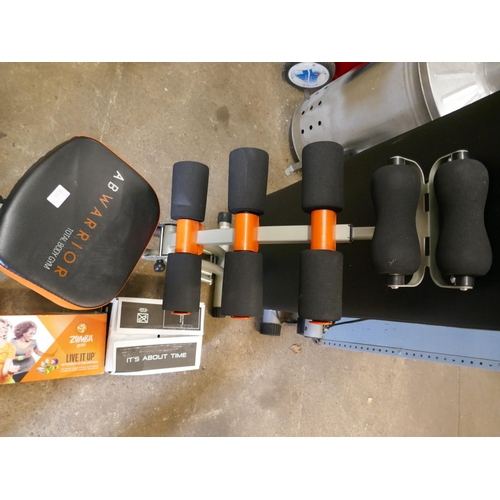A quantity of exercise equipment including Beachbody Focus T25 exercise