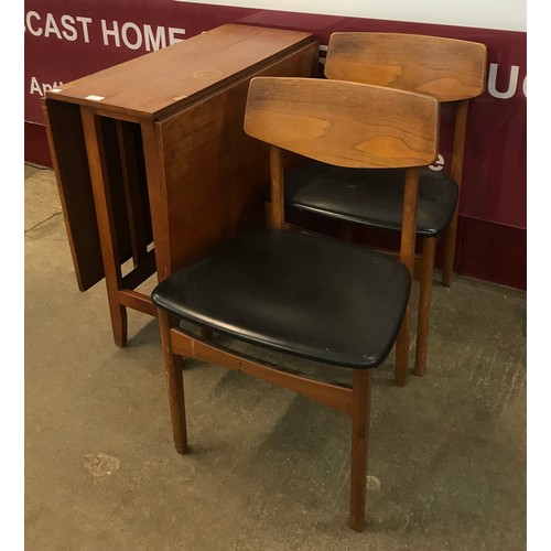 30 - A teak drop-leaf table and two chairs