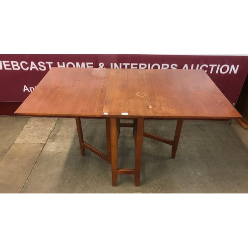 30 - A teak drop-leaf table and two chairs