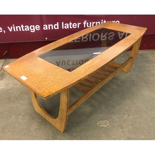 31 - A teak and glass topped rectangular coffee table