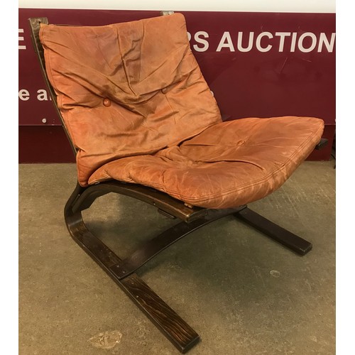 32 - A Danish Komfort bentwood and brown leather lounge chair