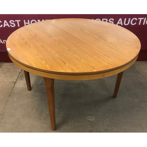 45 - A teak circular extending dining table