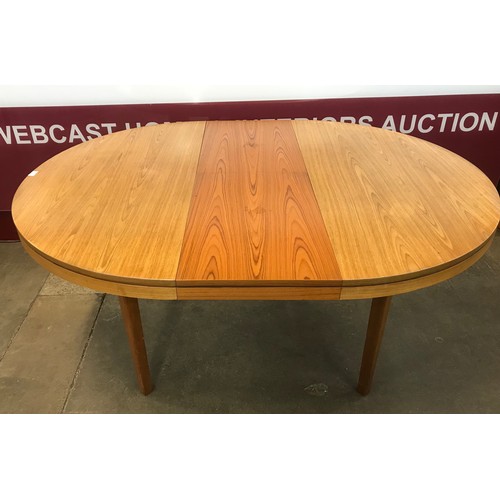 45 - A teak circular extending dining table