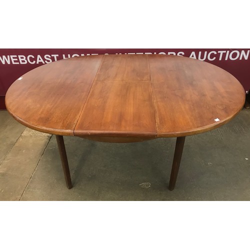 64 - A teak circular extending dining table