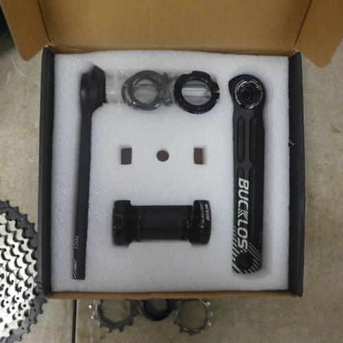 5107 - A quantity of bike items including a Bucklos bike crank kit, a bike seat and a free wheel bike casse... 