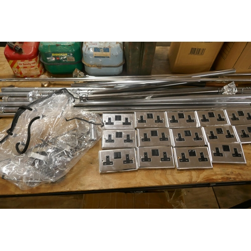 A collection of chrome curtain poles with fittings and fixtures and a ...