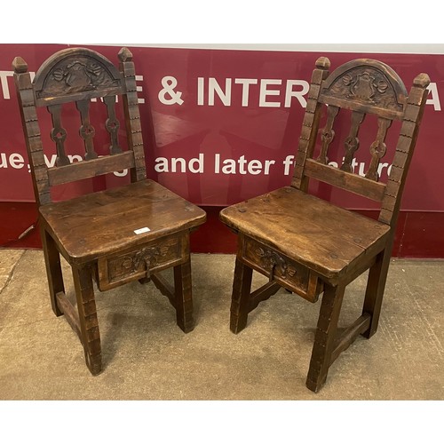 84 - A pair of French Gothic style carved hardwood chairs