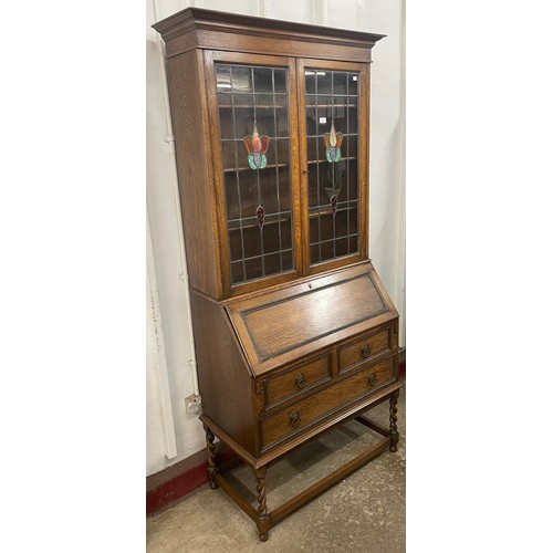 88 - An early 20th Century oak and stained glass two door bureau bookcase