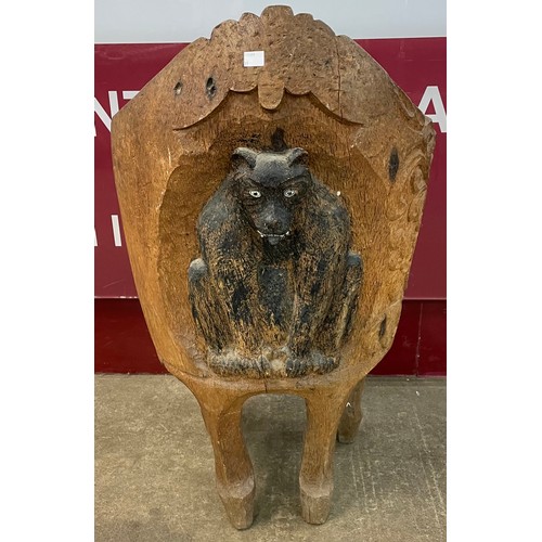 106 - An Anglo-Indian carved oak tub chair, depicting a mythical beast to back