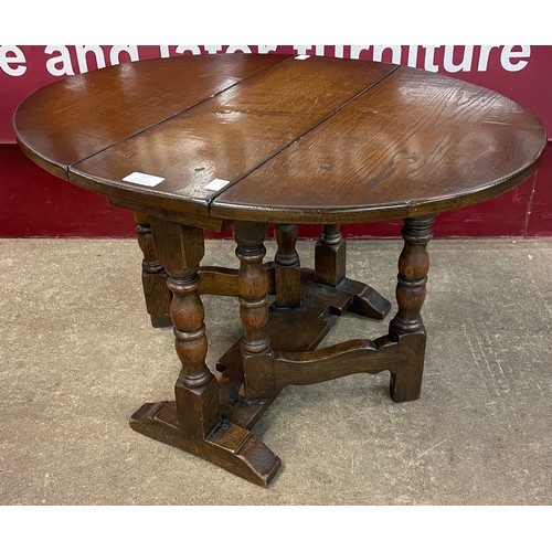 127 - An 18th Century style oak gateleg occasional table