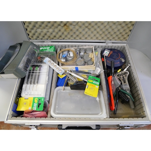 2106 - A collection of watch repair tools and equipment in an aluminium case