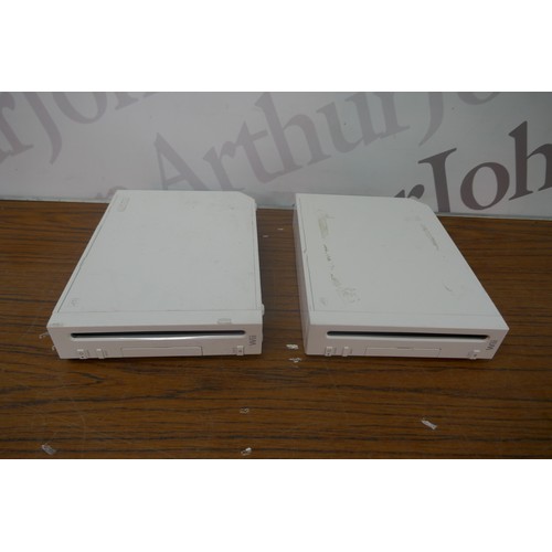 5117A - Two Nintendo WII first generation gaming consoles with genuine and after market accessories  all lea... 