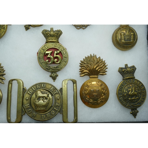 2206 - A collection of military regimental badges, mainly 19th century, also a buckle