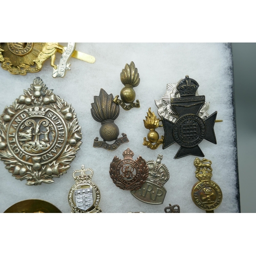 2219 - A collection of military regimental cap badges