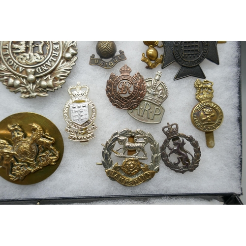 2219 - A collection of military regimental cap badges