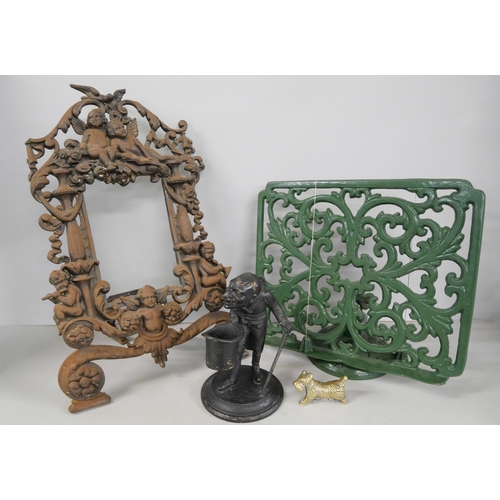 2247 - A Victorian cast iron picture frame, a cast iron music stand, a metal inkwell in the form of a man w... 