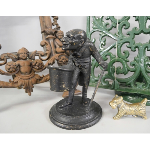 2247 - A Victorian cast iron picture frame, a cast iron music stand, a metal inkwell in the form of a man w... 