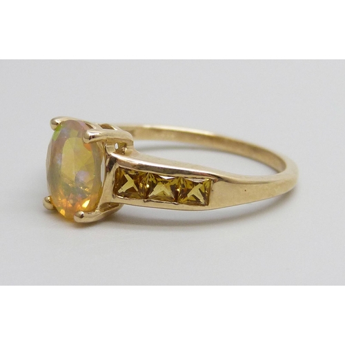 7002 - A 9ct gold ring set with an Ethiopian opal and yellow stones, 2.3g, N/O