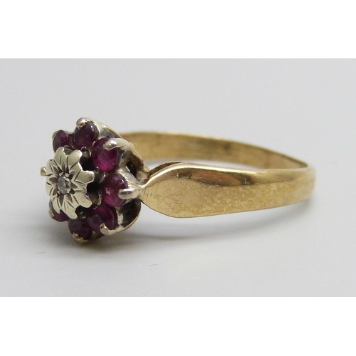 7003 - A 9ct gold ring set with rubies and a diamond, 2.5g, M