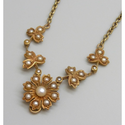 7023 - A c1900 yellow metal necklace set with seed pearls, 8.9g, 41cm