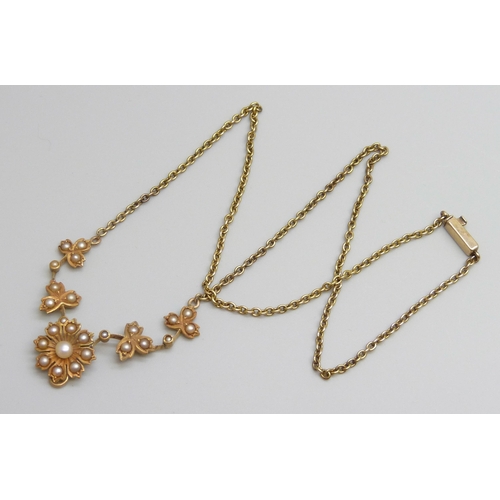 7023 - A c1900 yellow metal necklace set with seed pearls, 8.9g, 41cm