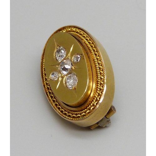 7030 - A Victorian yellow metal brooch set with five diamonds, 4.8g, 22mm