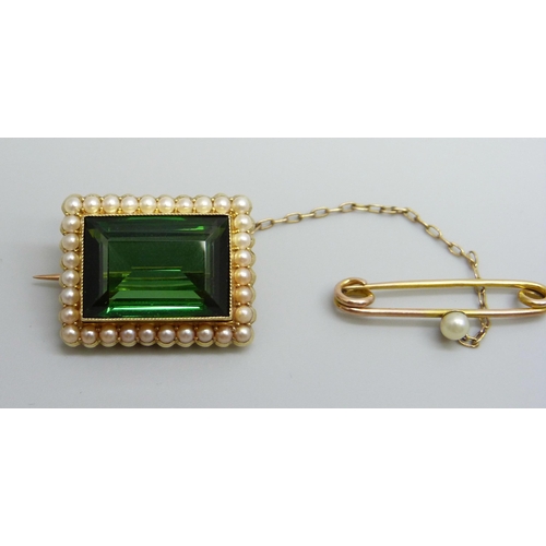 7034 - A 15ct gold brooch set with a green stone and a seed pearl border with a 9ct gold safety pin set wit... 