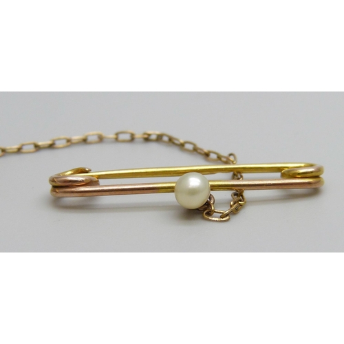 7034 - A 15ct gold brooch set with a green stone and a seed pearl border with a 9ct gold safety pin set wit... 