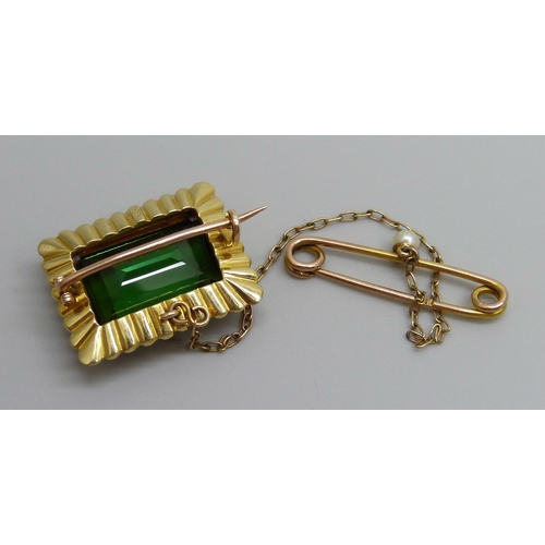 7034 - A 15ct gold brooch set with a green stone and a seed pearl border with a 9ct gold safety pin set wit... 