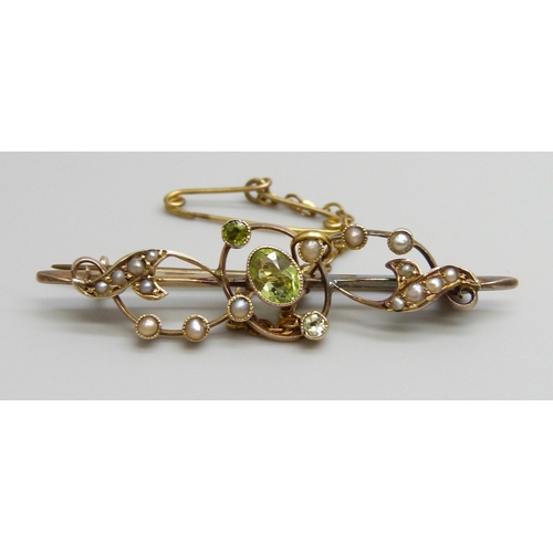 7036 - A 9ct gold bar brooch set with seed pearls and peridot, 2.9g