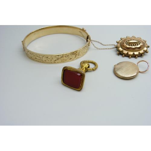 7037 - A 9ct gold metal core bangle, a gilt metal fob, a yellow metal memorial brooch and a yellow metal lo... 