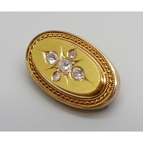 7039 - A Victorian yellow metal brooch set with five diamonds, 4.9g, 22mm