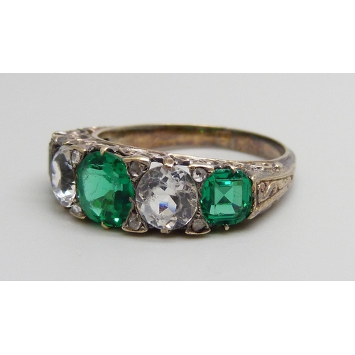 7046 - An 18ct golf ring set with white and green stones, 4.8g, Q, (three central stones scratched)