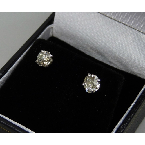 7054 - A pair of hallmarked 18ct white gold diamond stud earrings, total diamond weight 1.31ct