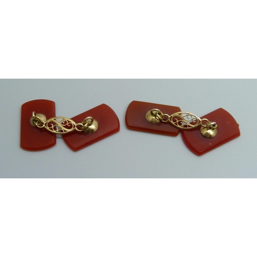 7063E - A pair of carved carnelian cufflinks, 2 x 1.2cm