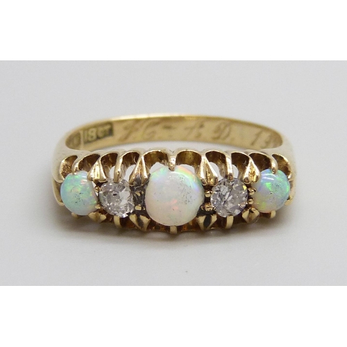 7069 - An 18ct gold, opal and diamond ring, 3.4g, N/O, boxed, one opal chipped