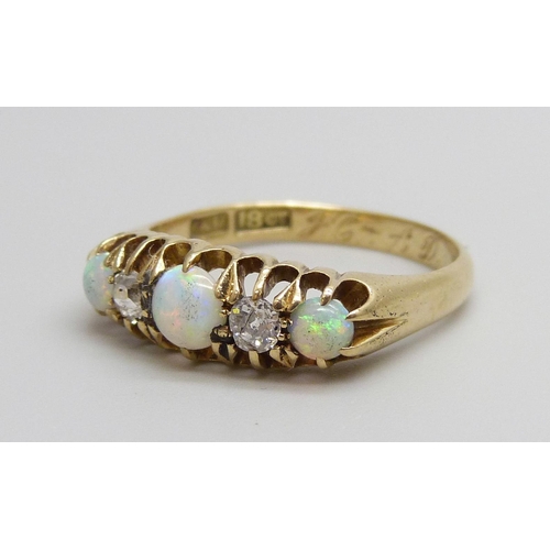 7069 - An 18ct gold, opal and diamond ring, 3.4g, N/O, boxed, one opal chipped